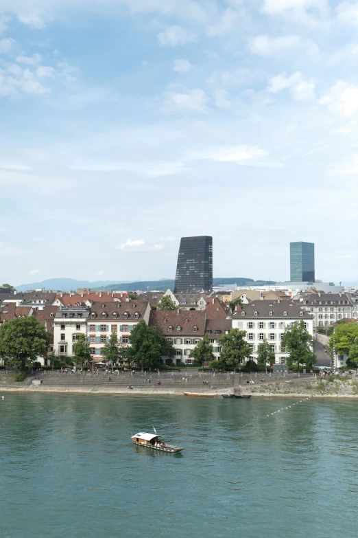 a boat is on the water in front of a city