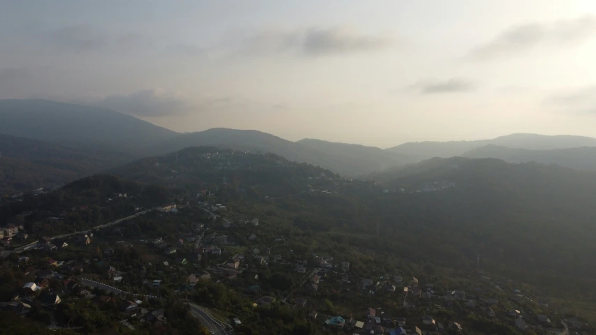 aerial s of some hills and trees on cloudy day