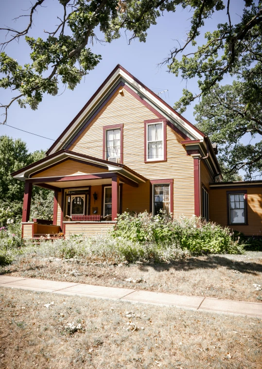 a house with red trim on a street