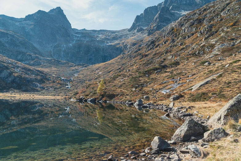 some mountains and water in the middle of the day