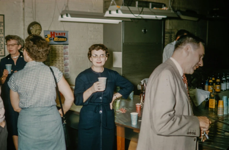 people are gathered at a bar and there is a drink in the cup