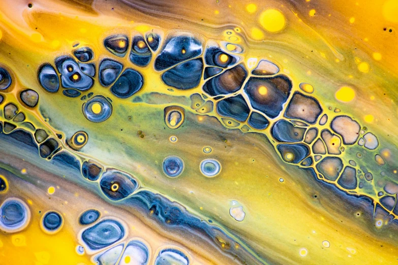 a liquid droplet that is yellow and blue