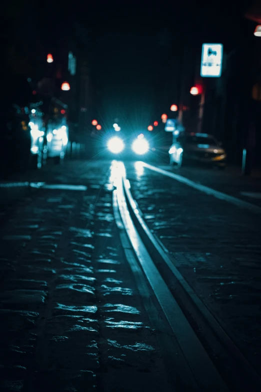 cars passing by on a city street at night