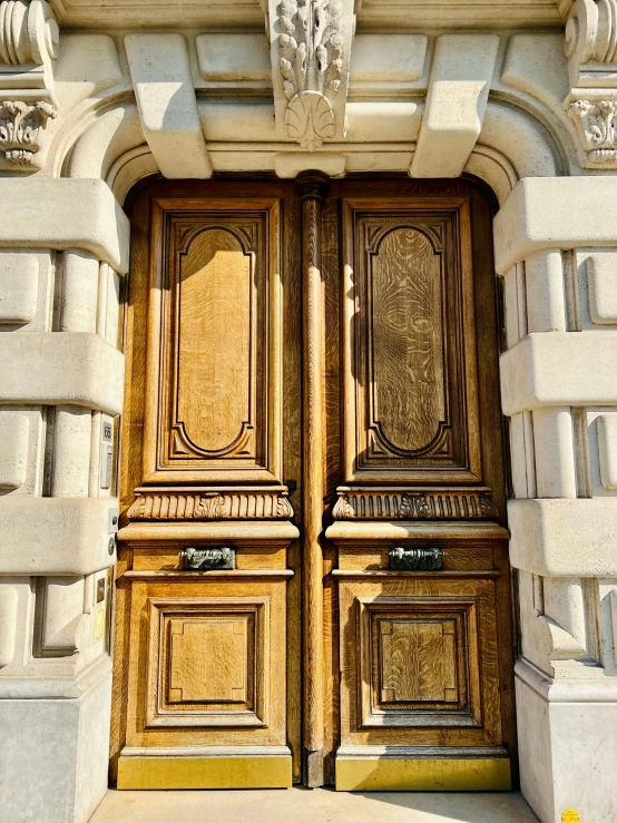 two large doors sitting in front of a large building