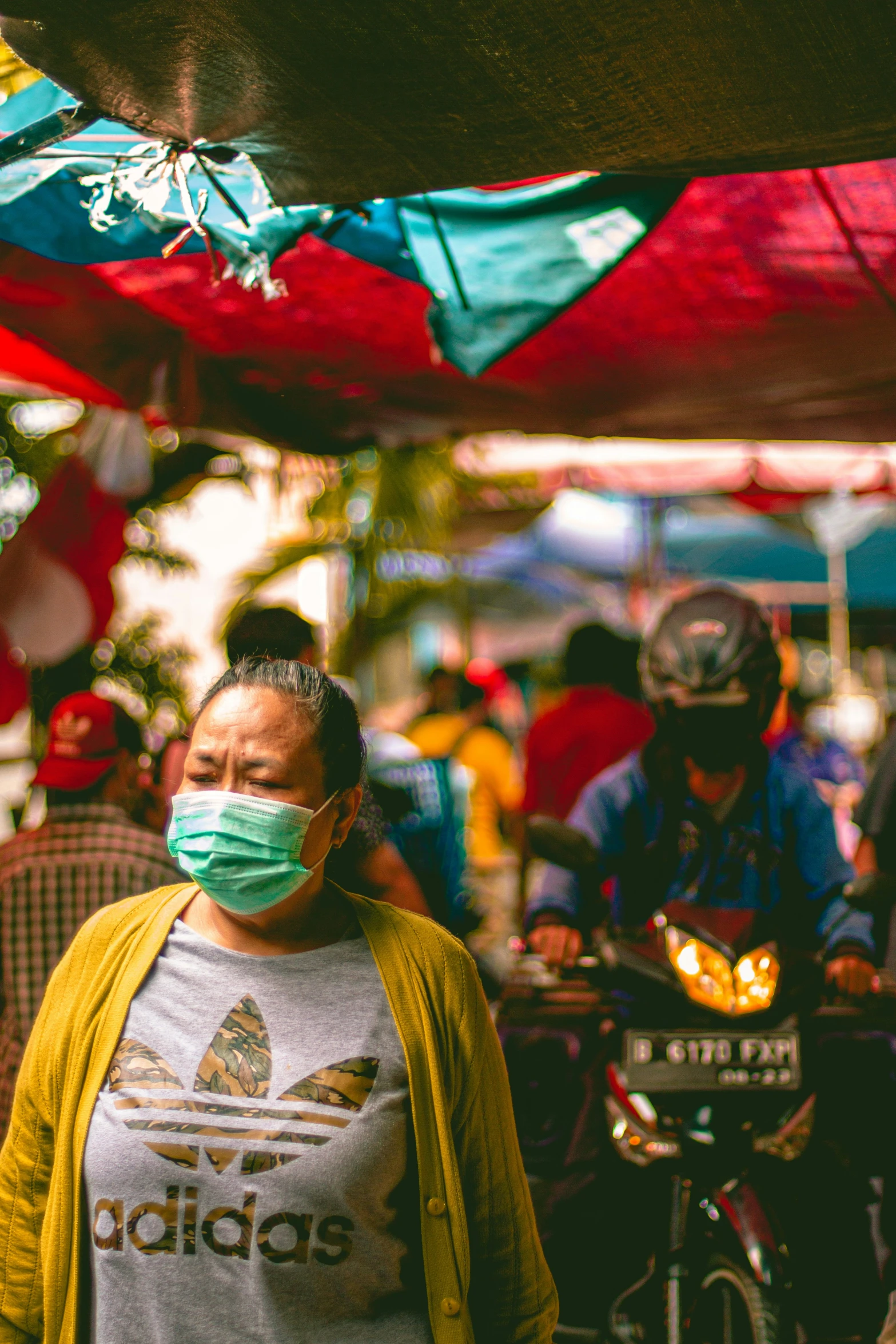 a lady wearing a mask standing in the street