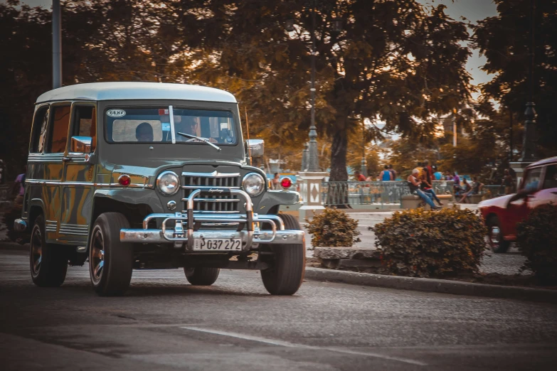 an older looking truck is driving down the street