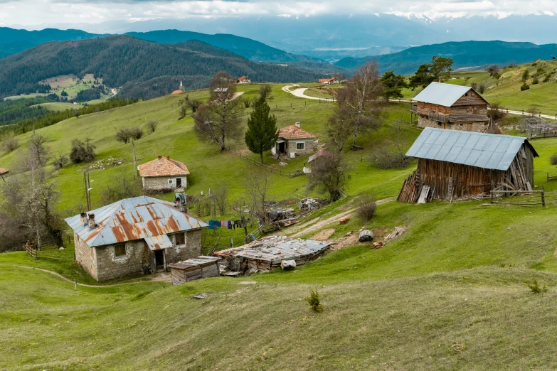 a hill top with several small barns and other buildings