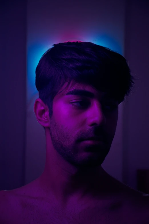 a man standing in front of a colorful light
