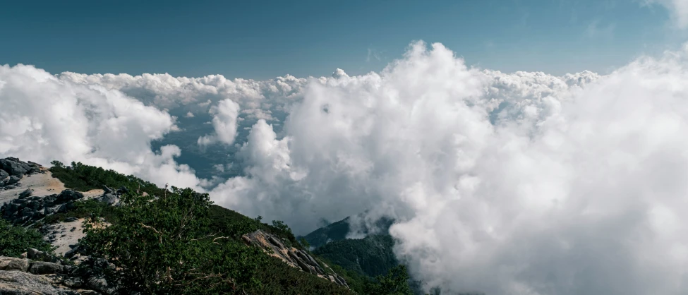 the clouds over a hill are very large