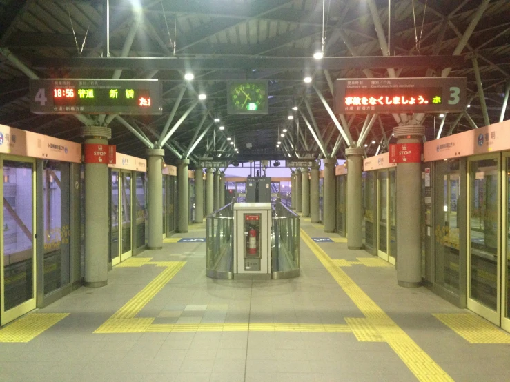 an empty train station with windows and signs