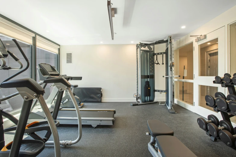 this home gym has machines and equipment inside of it