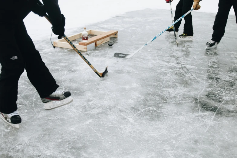 two guys playing a game of hockey with sticks