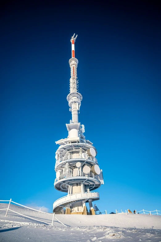 a very tall tower with a clock on it's side