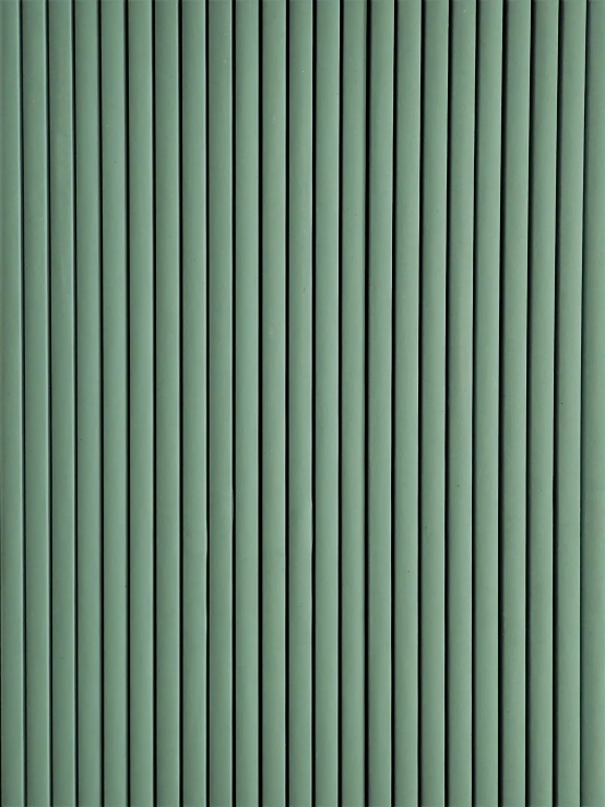 a green wall with vertical lines of different sizes