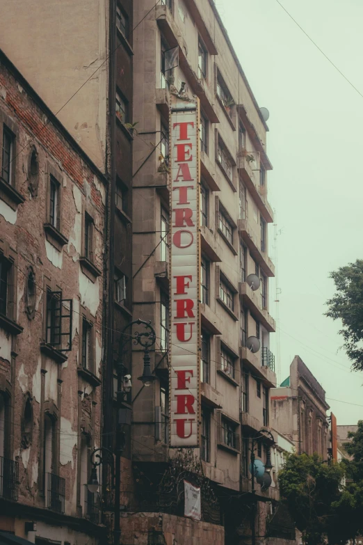 a big tall building with an advertit for a theater on it