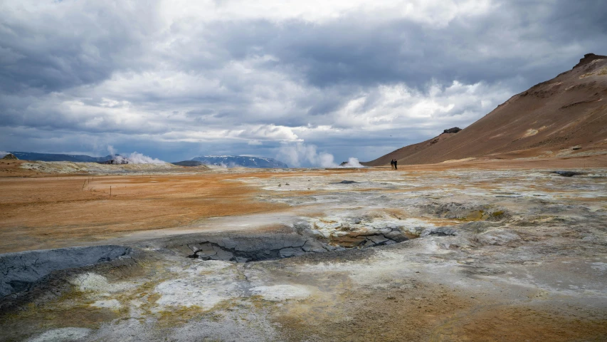 a person standing in an open, barren landscape