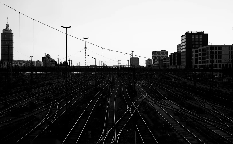 trains moving together in the distance along with many skyscrs