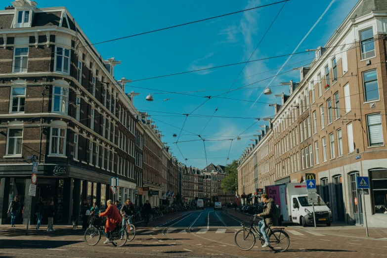 three people riding bikes on an empty street