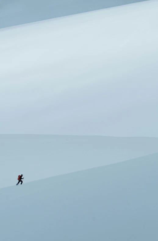 a man is skiing across a snow covered mountain