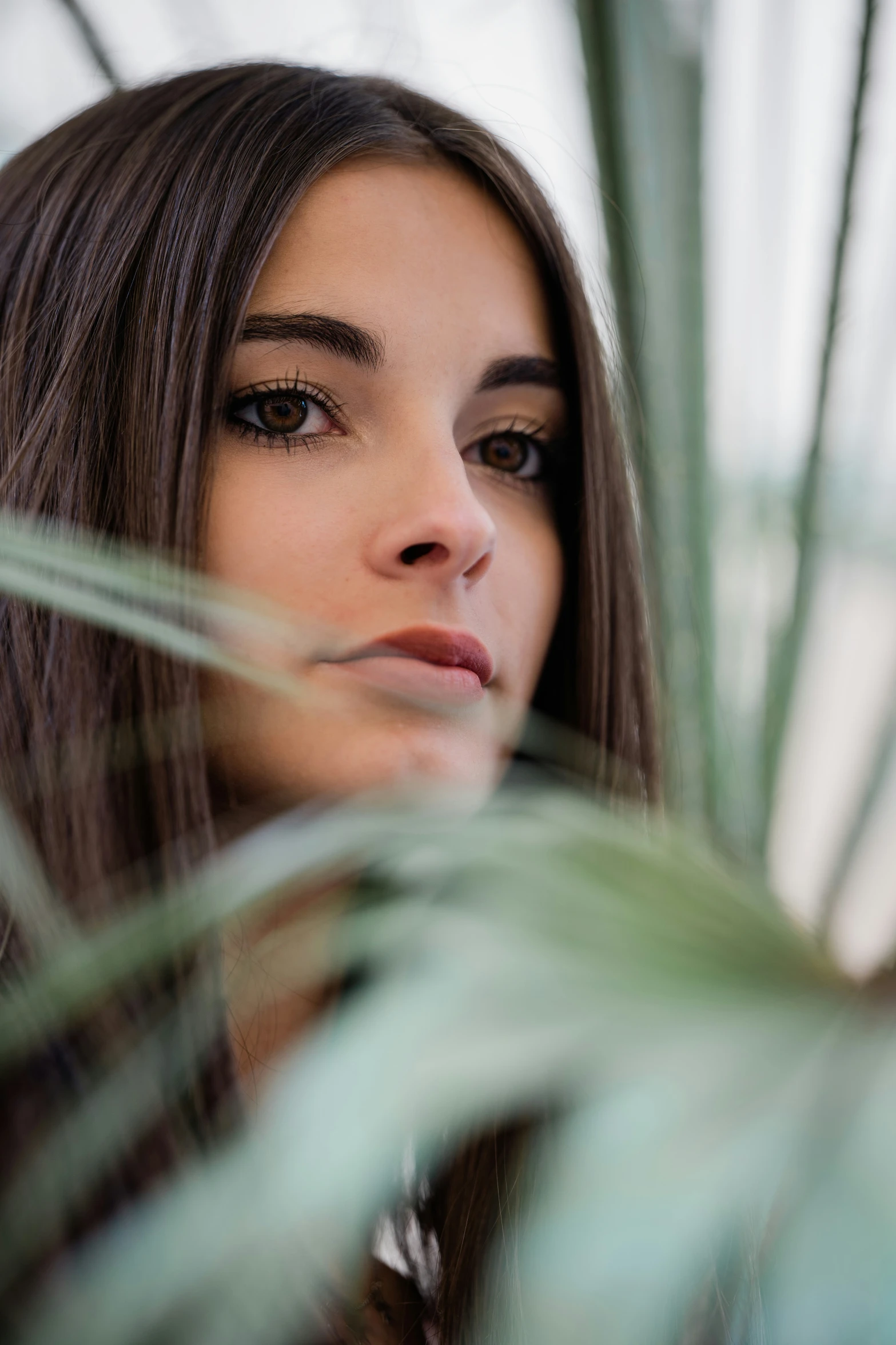 a woman with long hair looking off to her side