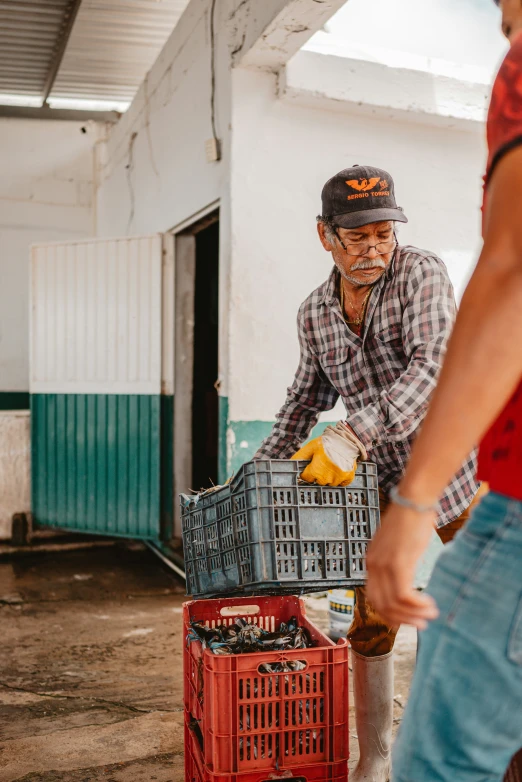 a man cleaning the house's floor with a wheelbarrow