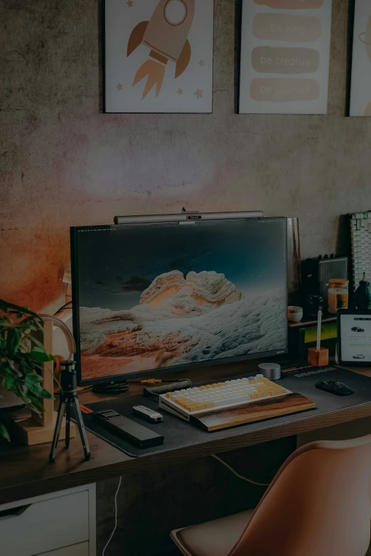 a desk with laptop computer, phone and other office supplies on it