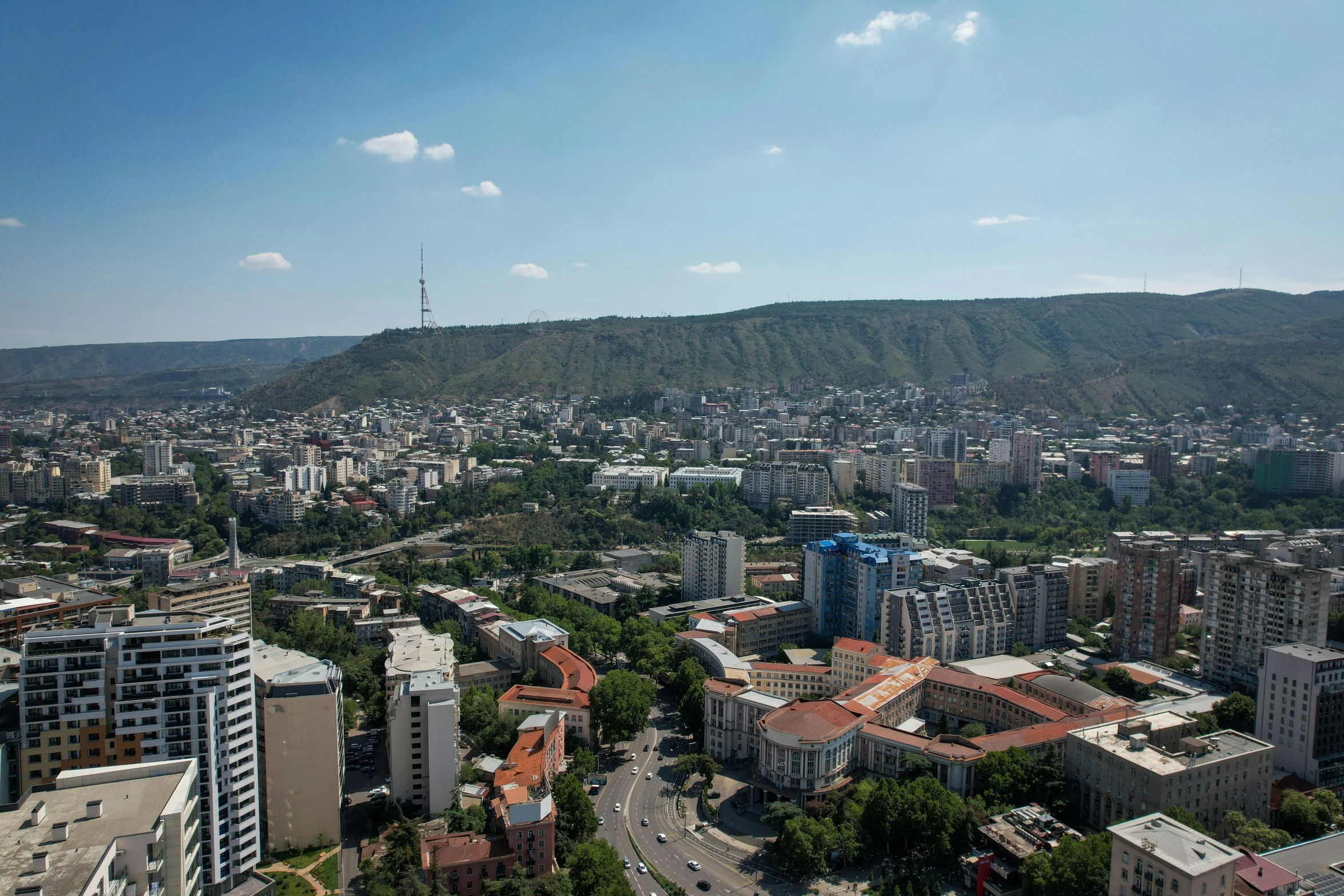 a city with a tall hill in the background