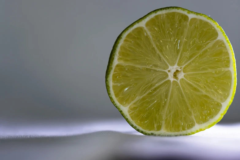 a lemon fruit is on a white surface