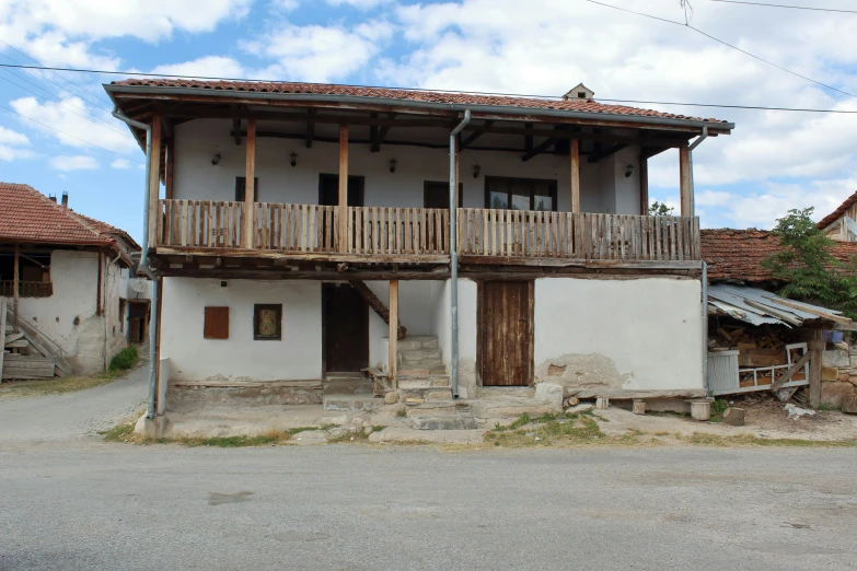 a wooden balcony over the side of a house