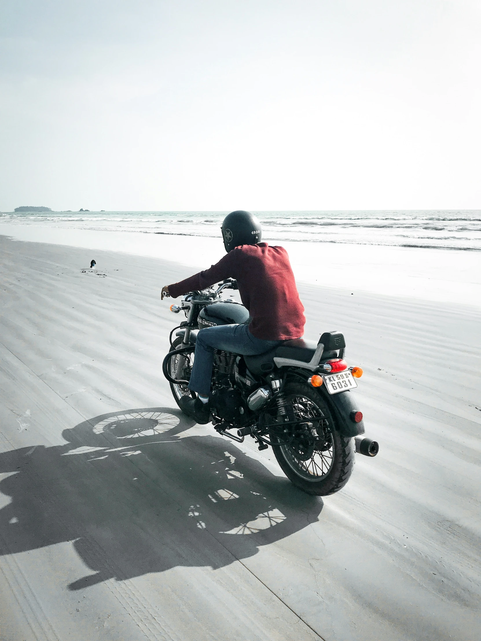 the person is riding a motorcycle on the beach