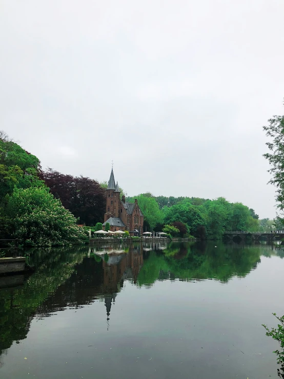 a body of water near some buildings and trees