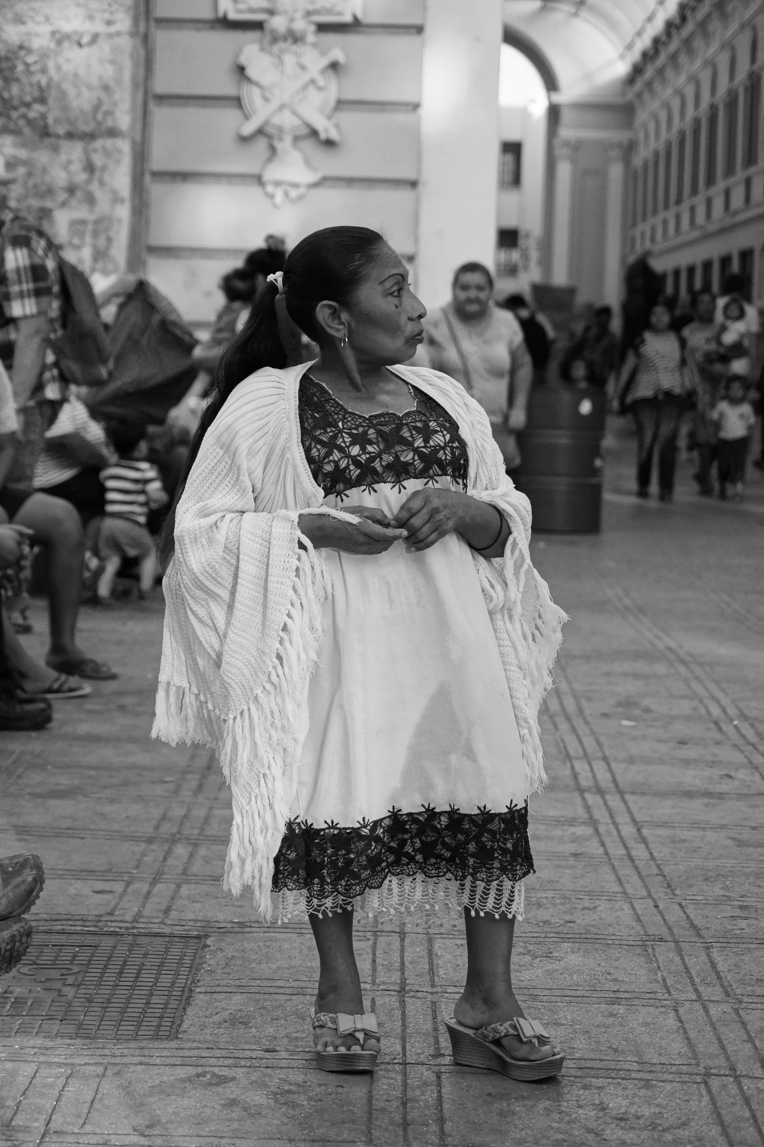 black and white pograph of woman with frocks and jacket