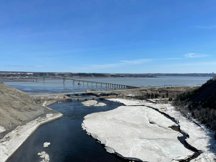 some ice laying on the water and snow