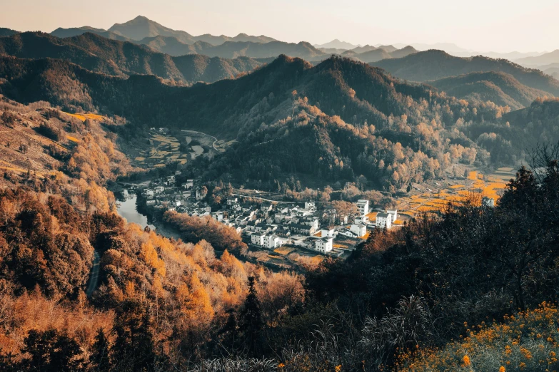 an aerial view of a town perched in the valley of some sort