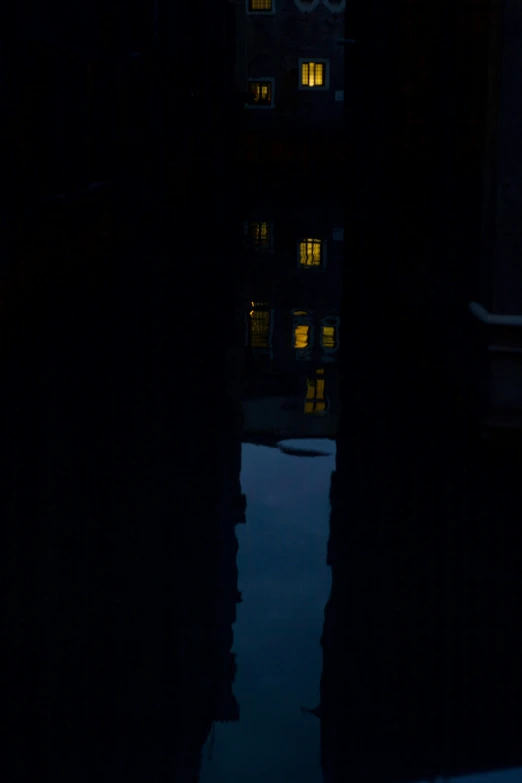 a reflection of a building at night in water