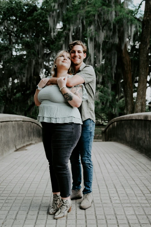 two people emce near a tree with moss on them