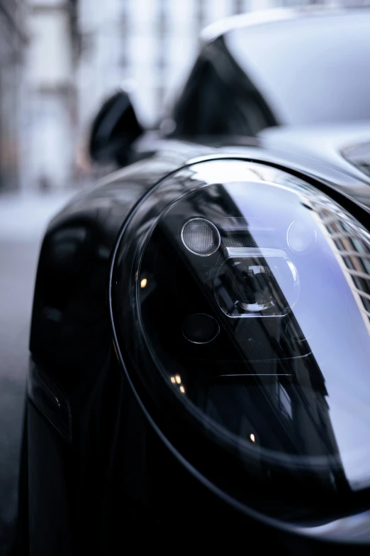 the front view mirror of a sports car on the street