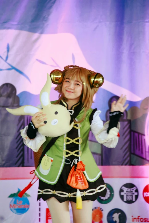 a girl in a costume holds a stuffed animal