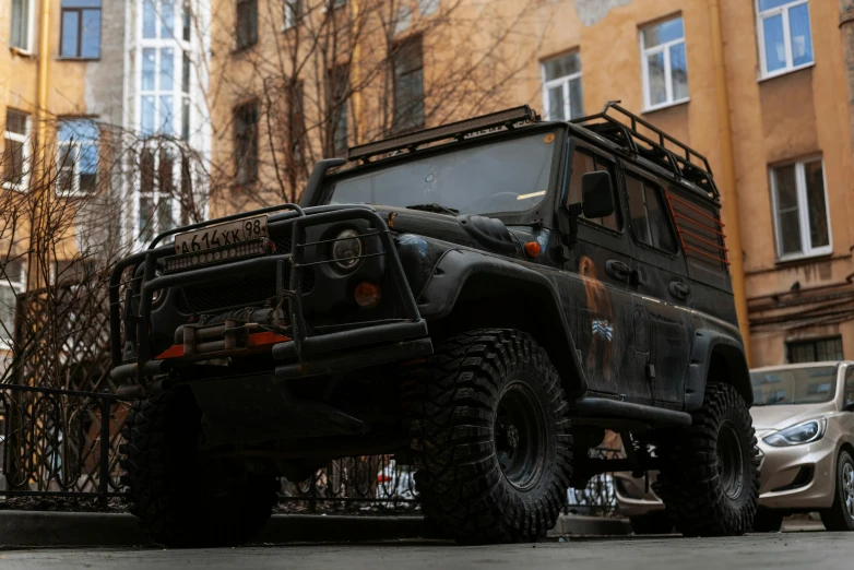 there is a military vehicle parked by the building