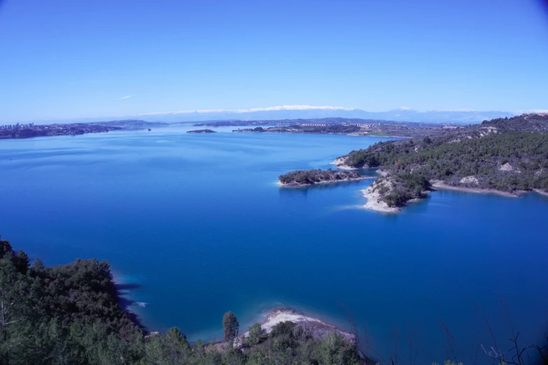 a blue lake surrounded by trees and mountains