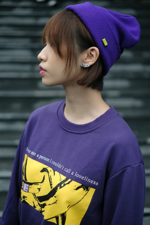 an asian female with a purple hat on