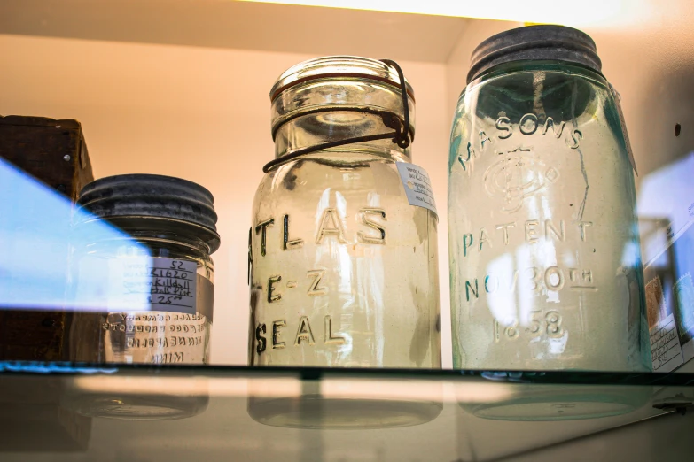 mason jars, on top of the shelf in a storage container