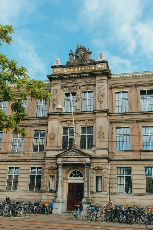 a very large building with lots of bicycles parked outside