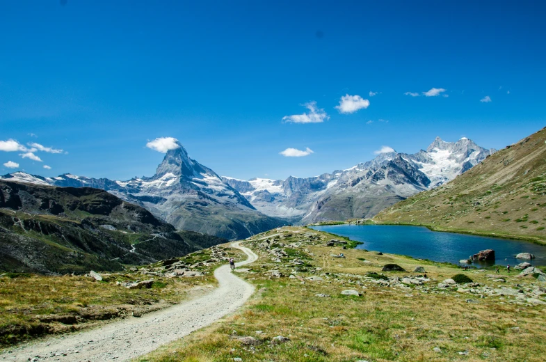 a dirt road on the side of a large mountain