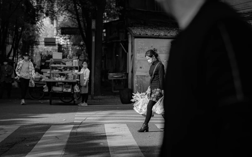 a woman holding flowers in her hand and walking away