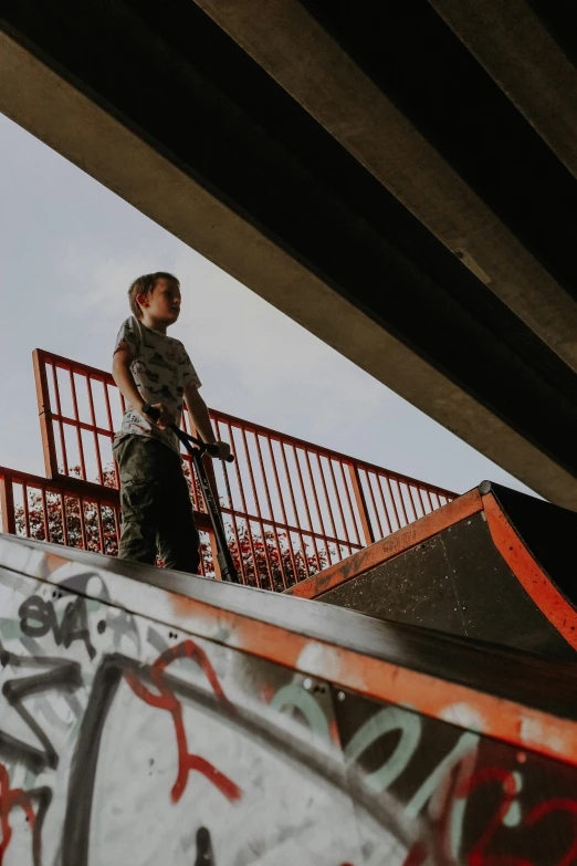 a boy on a skateboard going down a ramp