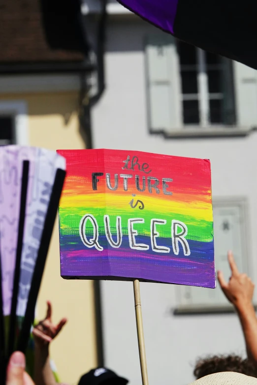 people gathered in the street holding up signs