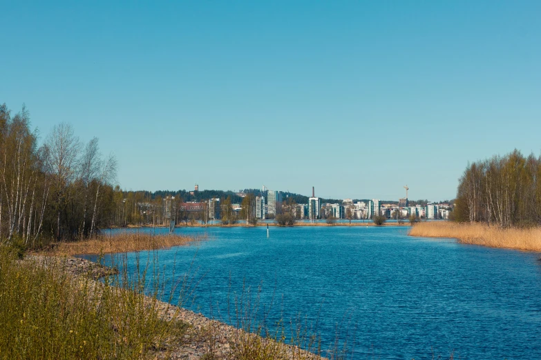 blue waters on a bright sunny day and a town in the distance