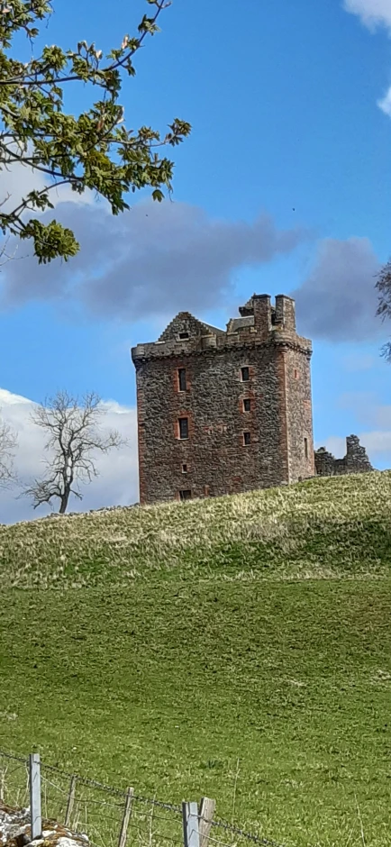 old ruins on a grass hill with an overhang