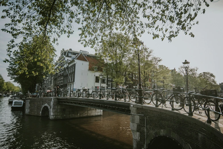 a bridge with bikes parked on it and cars driving down the street